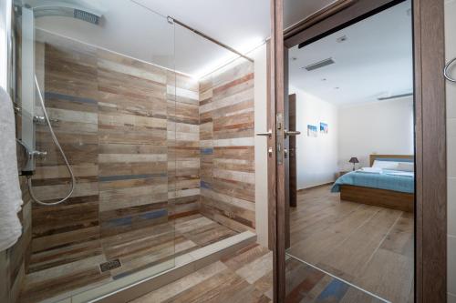 a bathroom with a shower with a glass door at Villa Denise in Kalyves