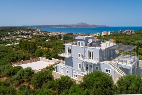 an aerial view of a white house on a hill at Villa Denise in Kalyves