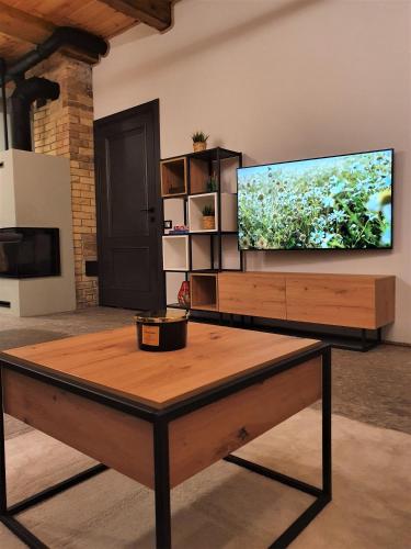 a living room with a large flat screen tv at KK Apartment in Ventspils