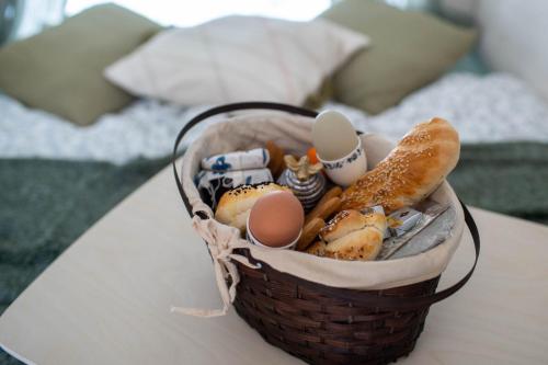 a basket of eggs and bread on a table at Beczki Pod Lasem in Trzemeśnia