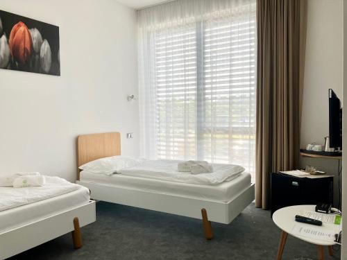 Postel nebo postele na pokoji v ubytování Penzion Zahradní
