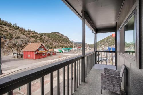 a balcony with a bench and a red building at Uplift Inn in Idaho Springs