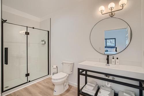a bathroom with a shower and a toilet and a mirror at Uplift Inn in Idaho Springs