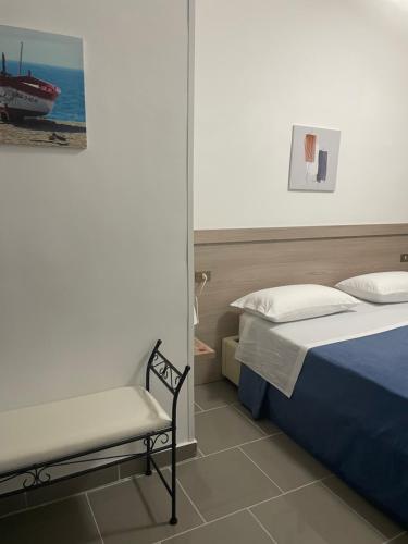 a bedroom with a bed and a chair in it at B&B House of Sun in Villapiana