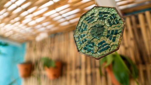 a stained glass object hanging from a wall at Residencial Águas de Bare in São Sebastião