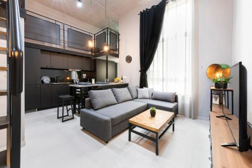 a living room with a couch and a kitchen at 248 Boutique Studios, Sliema in Sliema