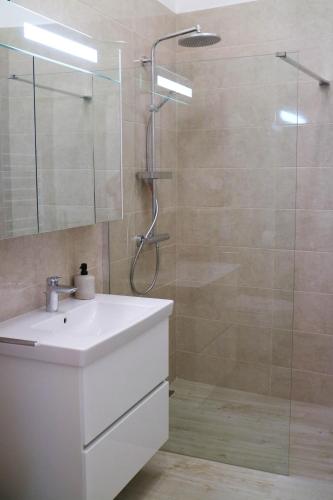 a bathroom with a white sink and a shower at Sessa's Palace in Korčula