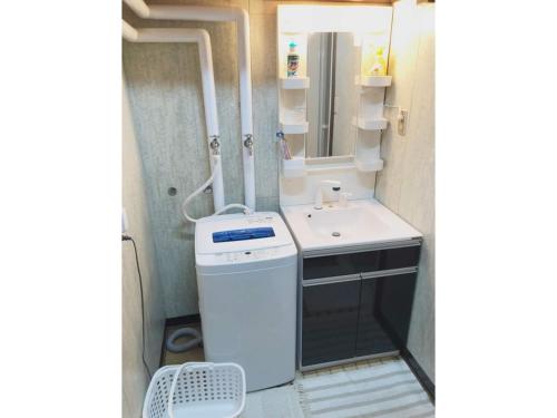 un piccolo bagno con lavandino e lavatrice di Guest House Nusa - Vacation STAY 12652 a Kushiro