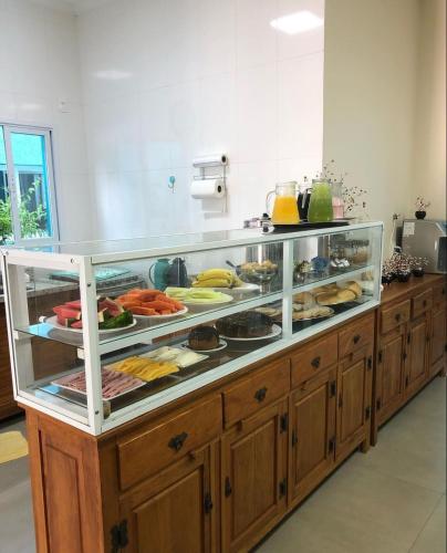 a buffet line with many different types of food at Residencial Águas de Bare in São Sebastião