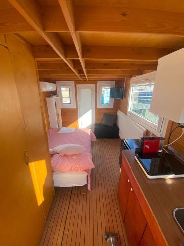 a small room with two beds and a kitchen at House boat R al Poetto 2 pax piu' 1 in Poetto