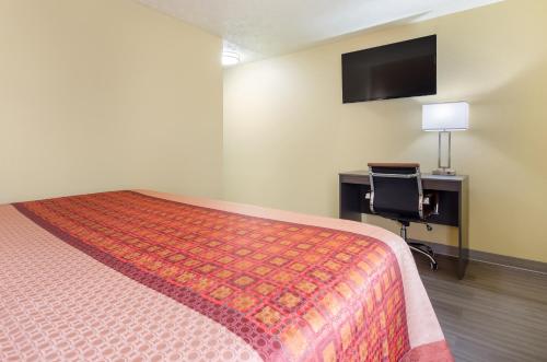 a bedroom with a bed and a desk and a television at Americas Best Value Inn & Suites Independence VA in Independence