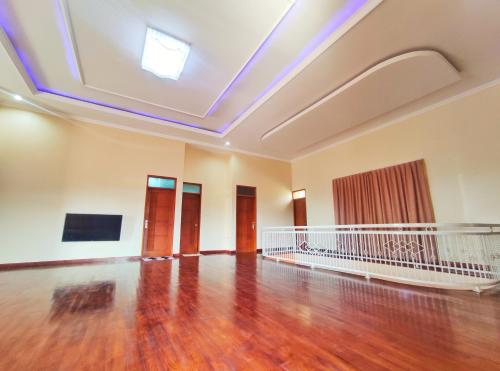 an empty room with a wooden floor and a skylight at Homestay Parikesit Rent Full House in Semarang