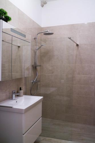a bathroom with a shower and a sink at Sessa's Palace in Korčula