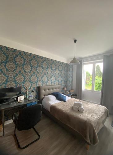 a bedroom with a bed and a desk and a chair at LA MAISON DE BARLEST - LOURDES in Barlest