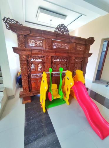 a childs play set in front of a bed at Homestay Parikesit Rent Full House in Semarang