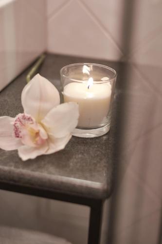 a candle and a flower on a table at The Embassy Suites in Sofia