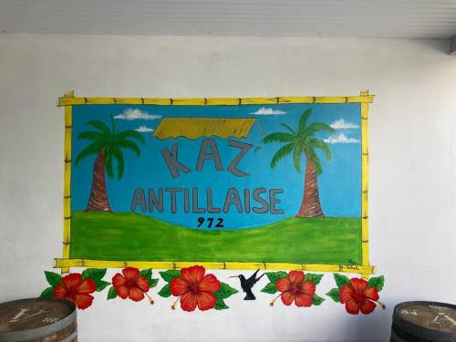 un cartel en una pared con palmeras y flores en KAZ'ANTILLAISE APPT AVEC PISCINE TI MAEVA 3/4P. LE LAMENTIN, en Le Lamentin
