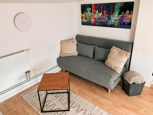 a living room with a couch and a table at Karowlina Cozy House Berlin 1-4 Person in Berlin