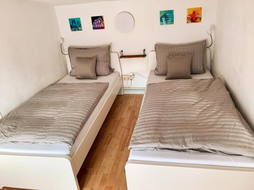 two beds in a small room with two mattresses at Karowlina Cozy House Berlin 1-4 Person in Berlin