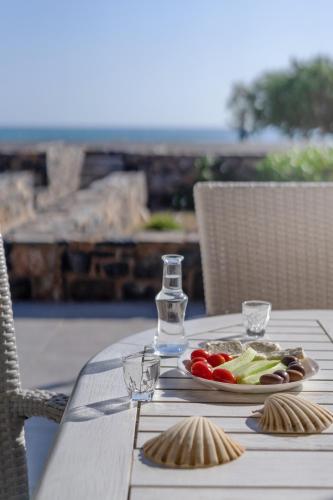 a table with a plate of vegetables on it at Blue Coast House in Goúdhouros