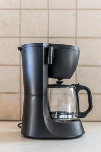 a black coffee maker sitting on top of a counter at Blue Coast House in Goúdhouros