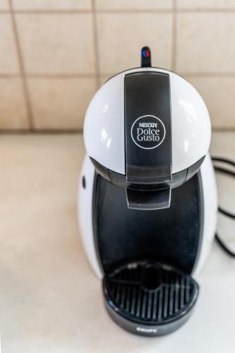 a black and white mixer sitting on a counter at Blue Coast House in Goúdhouros