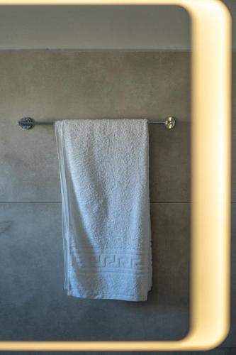 a towel hanging on a towel rack in a bathroom at Blue Coast House in Goúdhouros