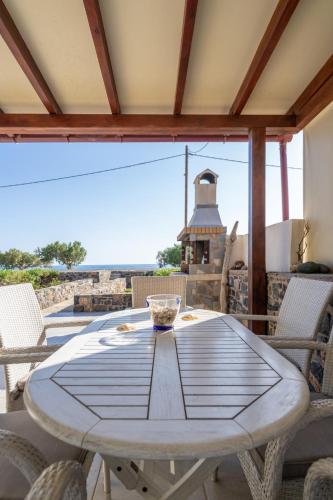 a table on a patio with a view of the ocean at Blue Coast House in Goúdhouros