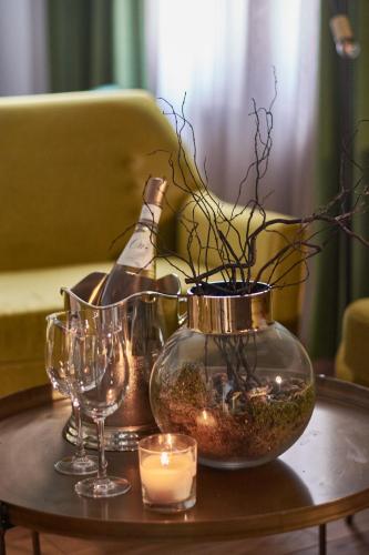 a table with glasses and a bottle and a candle at The Embassy Suites in Sofia