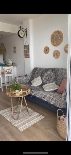 a living room with a couch and a table at sabanell park in Blanes