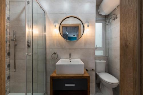 a bathroom with a sink and a toilet and a mirror at 248 Boutique Studios, Sliema in Sliema