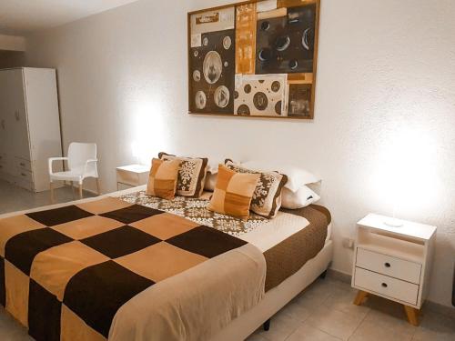 a bedroom with a bed with a checkered blanket at Casa Verde in San Rafael