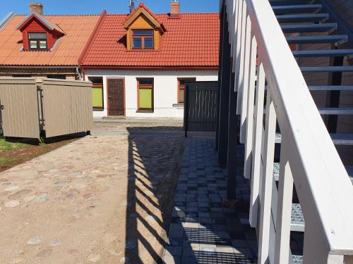 a building with a red roof and a bridge at KK Apartment in Ventspils