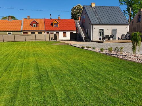 a large yard with a house and a house at KK Apartment in Ventspils