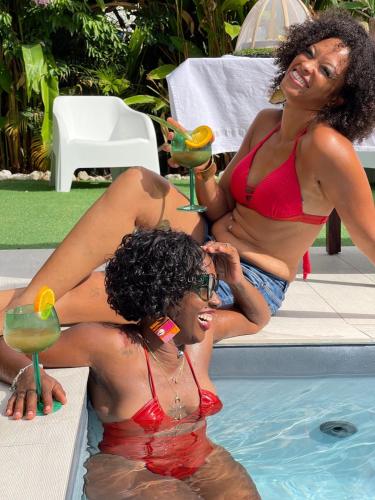 two women in bathing suits sitting in a swimming pool at Archipel Maimeo in Saint-François