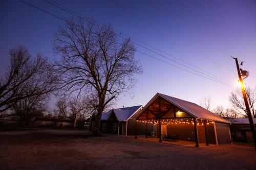 a barn with christmas lights on it at night at Knotty Squirrel Cabins in Mountain View