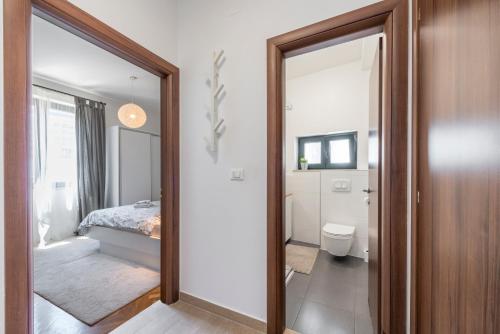 a bathroom with a mirror and a bedroom with a bed at 51 Street Apartment in Dubrovnik