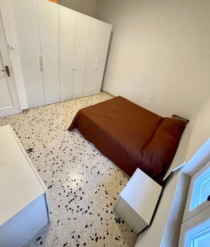 a small bedroom with a bed and white cabinets at Penthouse Panoramic in Pantelleria