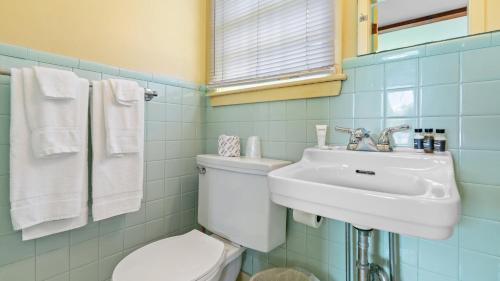 a bathroom with a toilet and a sink at Mid-Town Motel in Boothbay Harbor