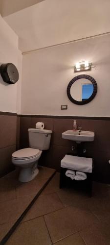 a bathroom with a toilet and a sink at Cayalito Apart Hotel in Guatemala