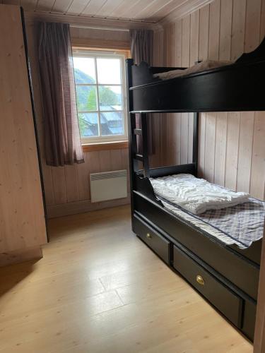 a bunk bed in a room with a window at Tinden in Hemsedal