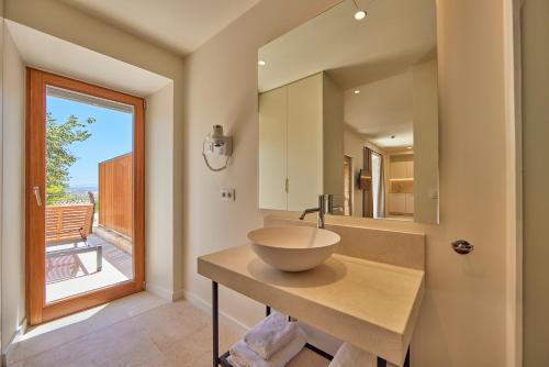 a bathroom with a bowl sink and a window at Finca Son Cladera in Sa Pobla