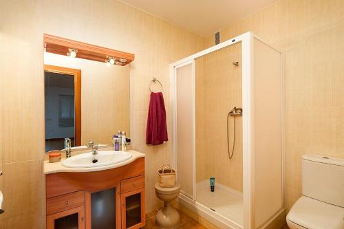 a bathroom with a sink and a shower and a toilet at Villa Reyes in Nerja