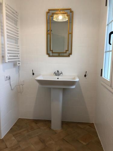 a bathroom with a sink and a mirror on the wall at La casita de El Montan Baja in Avilés