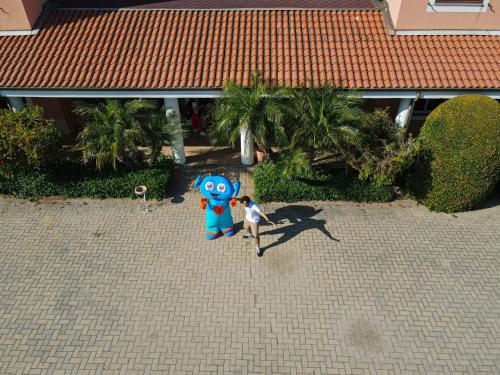 a person standing next to a large blue object at Futura Club La Praya in Pizzo