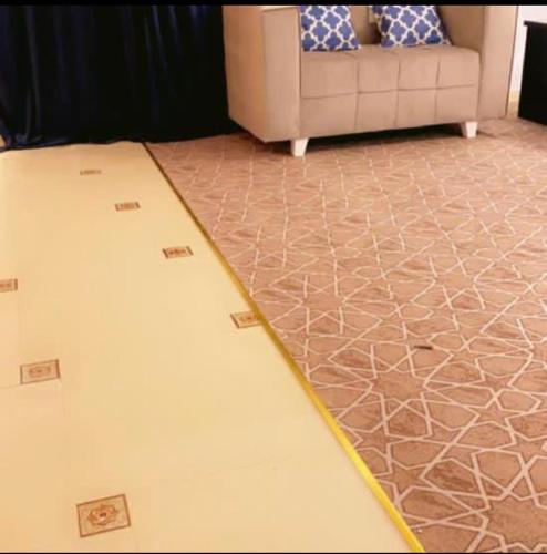 a living room with a couch and a carpet at هتان السودة Hattan Al Soudah in Suda