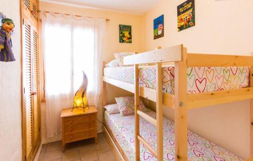a bedroom with two bunk beds and a window at Vistas al mar y a 100m de la playa in Son Parc
