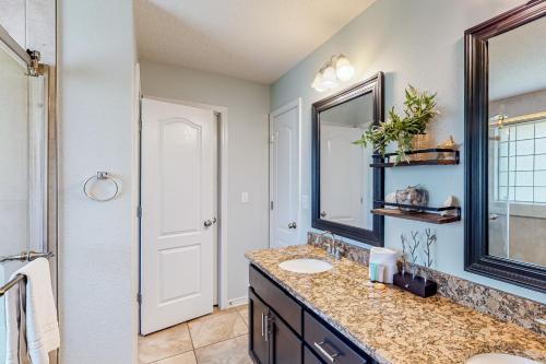 a bathroom with a sink and a mirror at Emerald Coast Dream Haven in Navarre