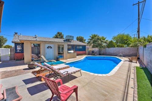 a backyard with a pool and chairs and a house at Las Vegas Getaway with Patio about 3 Mi to Strip! in Las Vegas