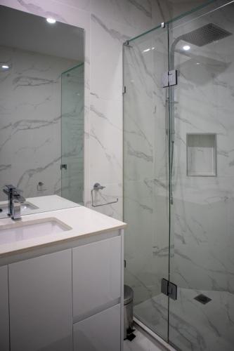 a bathroom with a sink and a glass shower at Soho 1A in Geelong